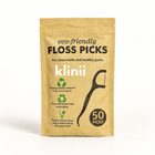 Klinii eco-friendly floss picks on a soft white and ivory background