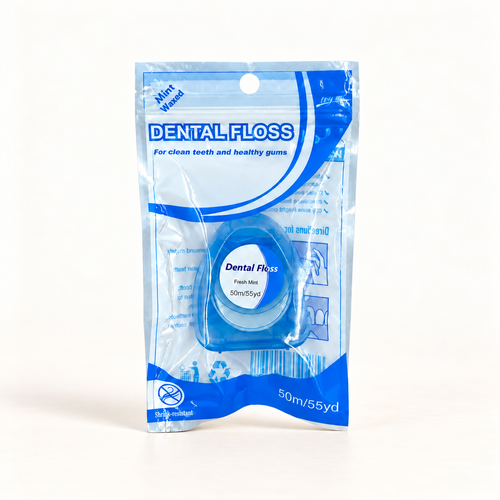 Klinii fluoride dental floss on a soft white and ivory background