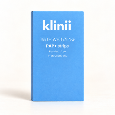Klinii PAP+ teeth whitening strips on a soft white and ivory background