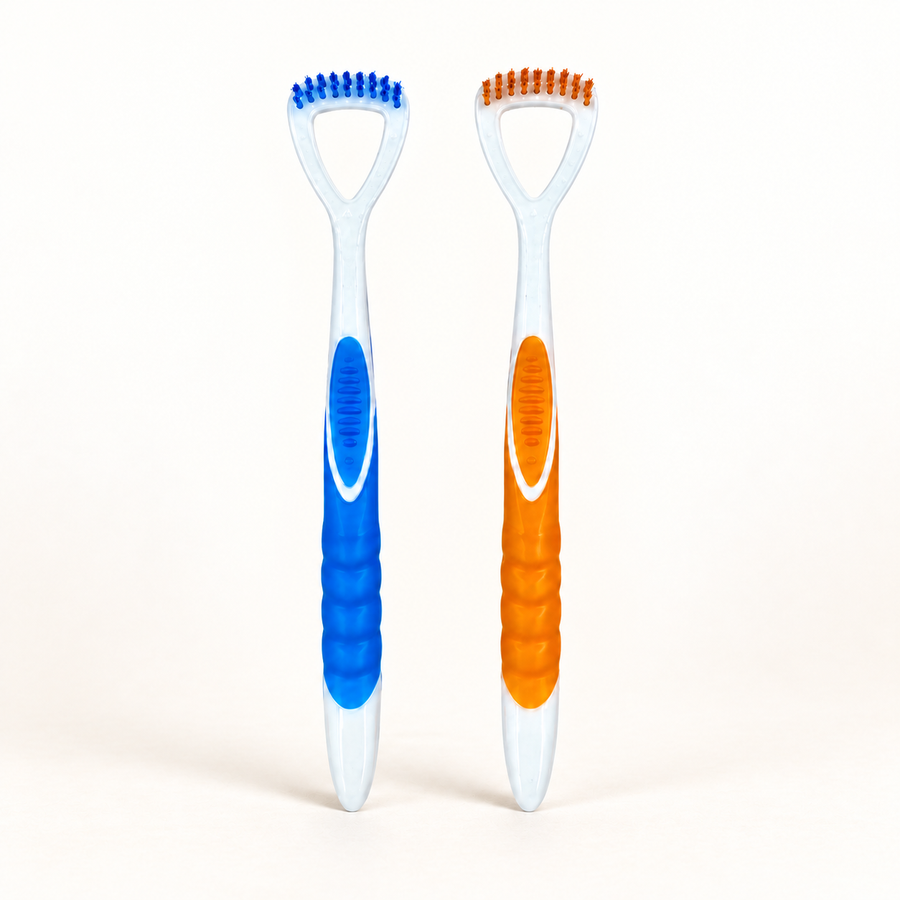 Blue and orange Klinii tongue cleaners on a soft white and ivory background