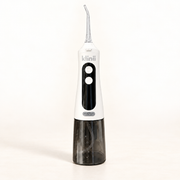 White Klinii Water Flosser on a soft white and ivory background