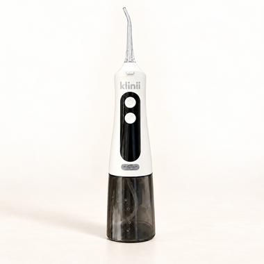 White Klinii Water Flosser on a soft white and ivory background